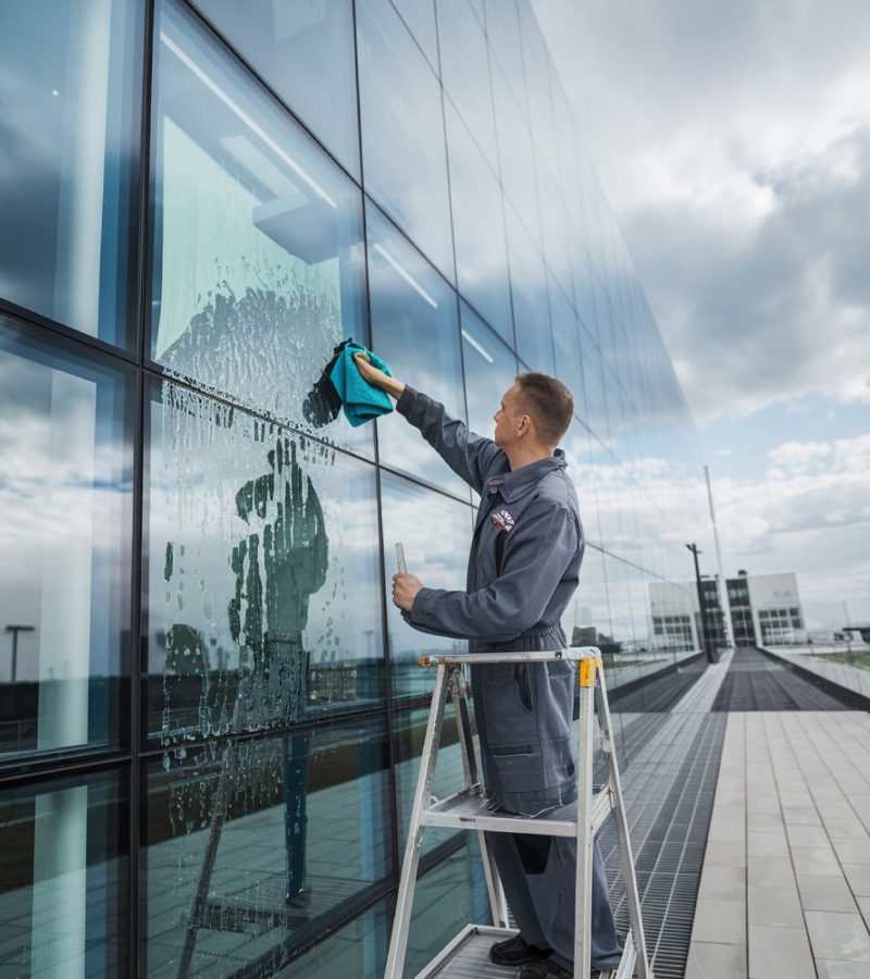 man-is-painting-wall-with-window-that-says-he-is-painting